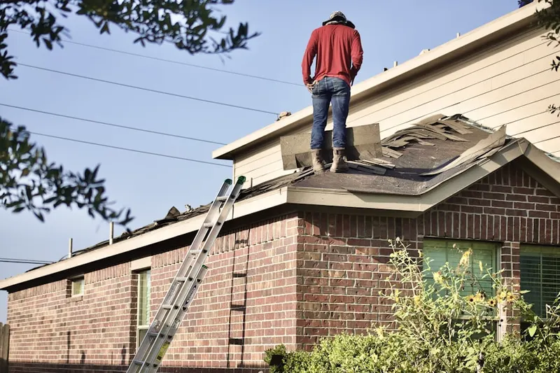 Professional roofer working on a residential roof in Alvarado